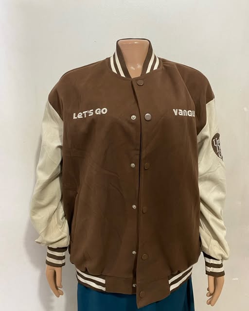 Chocolate varsity jacket shown on a mannequin at TAG-her