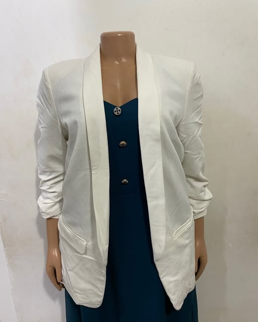 White open-front blazer layered over a teal garment