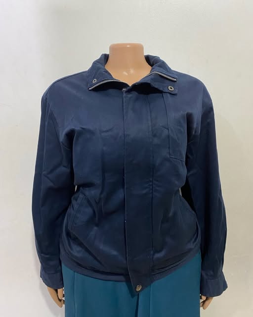 Navy zip jacket shown on a mannequin at TAG-her
