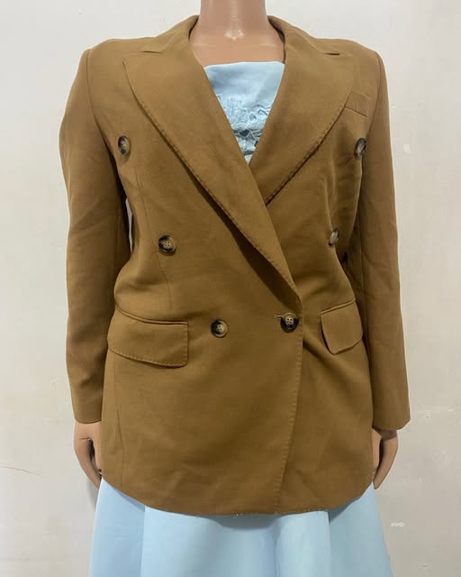 Camel double-breasted blazer shown on a mannequin at TAG-her